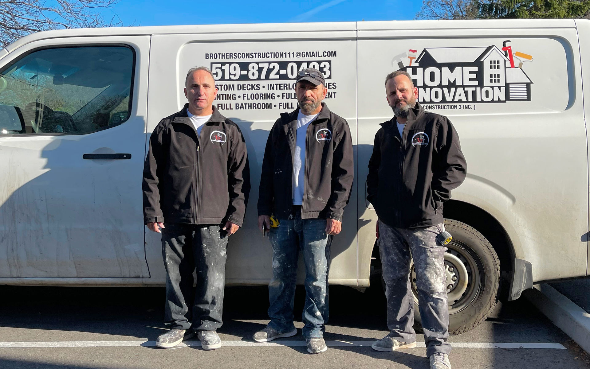 Brothers Construction 3. Three brothers in front of their company van. Home Renovations sign on the van. Logos. Phone number 519 872 0493. List of services listed on the van. Custom decks. Interlocking bricks. Painting. Flooring. Full Basements. Full Bathrooms.