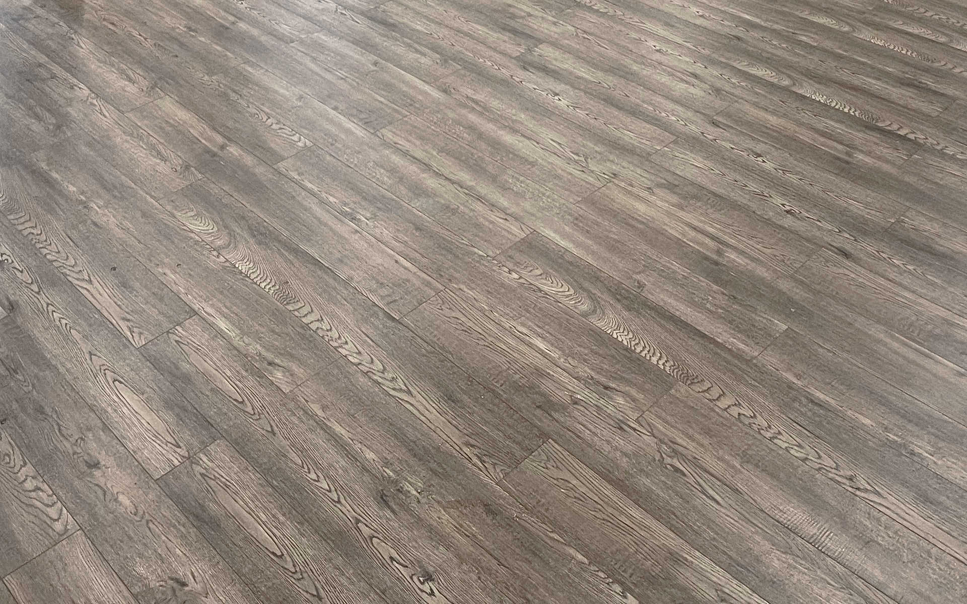 Modern grayish beige luxury vinyl, solid or engineered hardwood flooring. A London Ontario interiors / flooring renovation project by Brothers Construction.