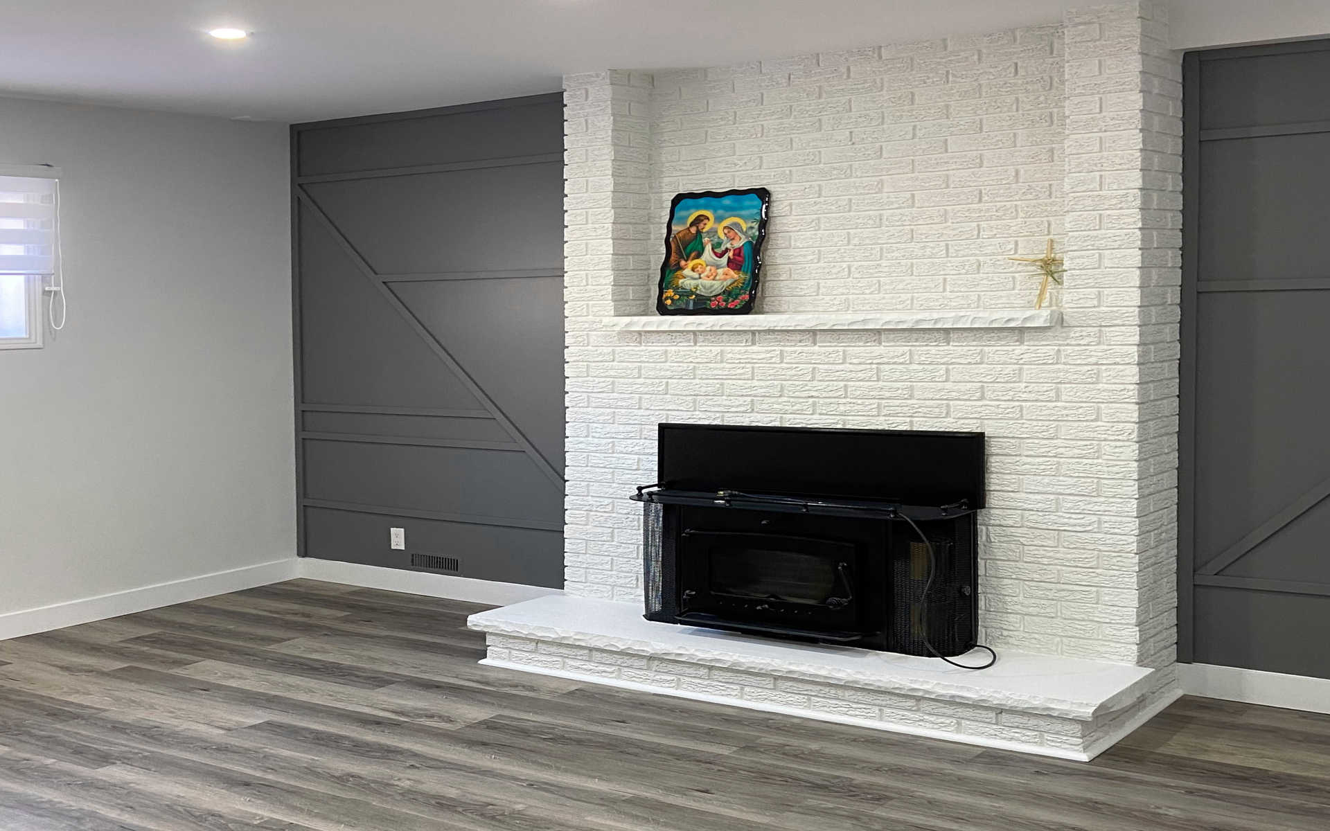 A modern living room with a fireplace. A London Ontario interiors / home renovation project by Brothers Construction.