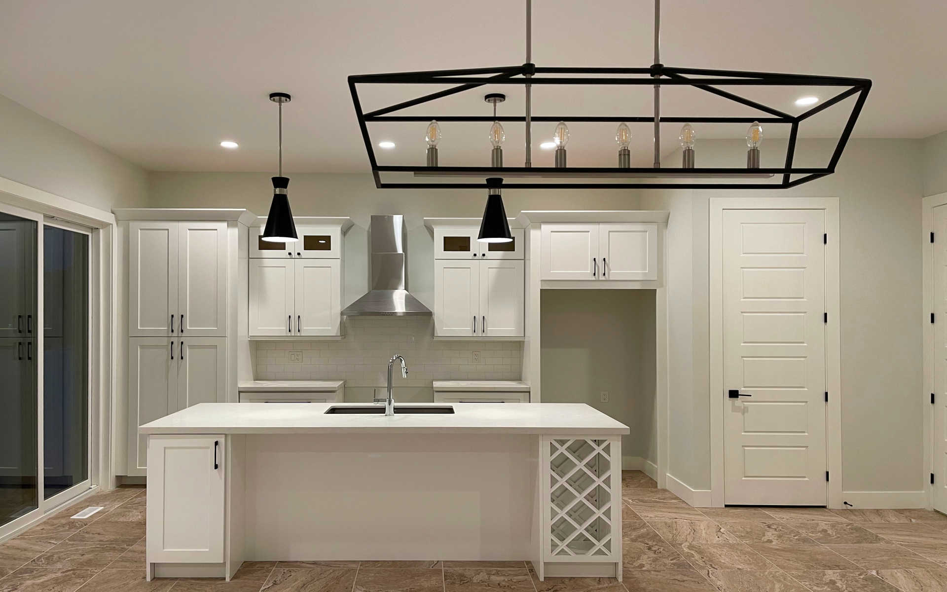 A modern kitchen design and renovation, cupboards, counter tops, kitchen island, flooring, painting and more. A London Ontario home and kitchen renovation project by Brothers Construction 3 Inc.